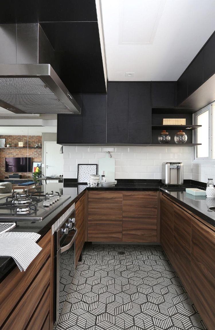 Cozinha com ladrilhos modernos deixando o ambiente mais moderno, armários marrom e preto, azulejo do metrô branco e coifa.