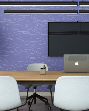 Parede com revestimento acústico roxo e com detalhes brancos, mesa de reunião e cadeiras